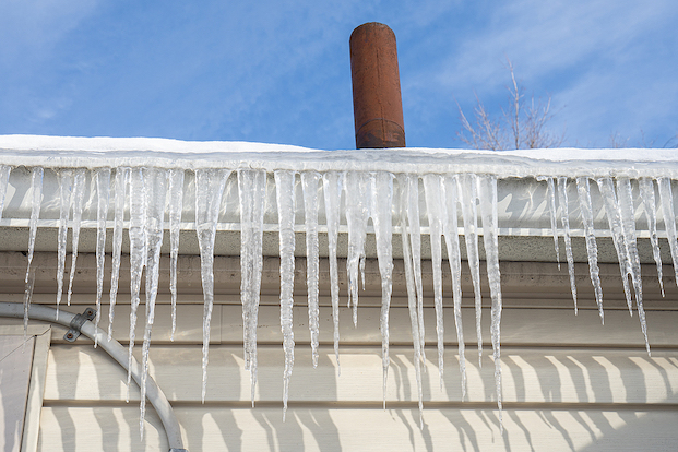 Icicles hanging from gutter along roofline